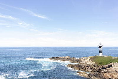 Scenic view of sea and buildings against sky