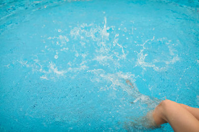 Low section of woman in swimming pool