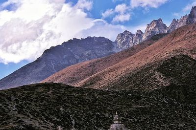 Scenic view of mountains against cloudy sky