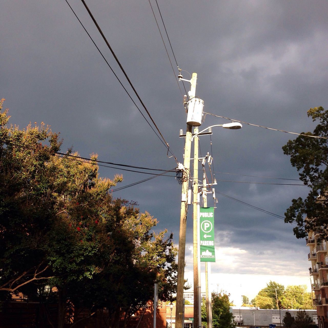 power line, electricity pylon, sky, tree, electricity, power supply, communication, fuel and power generation, low angle view, cable, cloud - sky, technology, transportation, cloudy, connection, road sign, road, pole, cloud, power cable