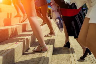 Low section of women standing on staircase