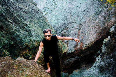 Young man standing on rock