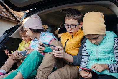 Portrait of happy family sitting in car