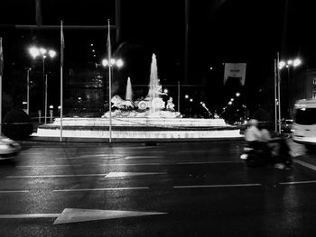 Cars on illuminated city at night