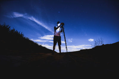 Full length of woman standing against sky