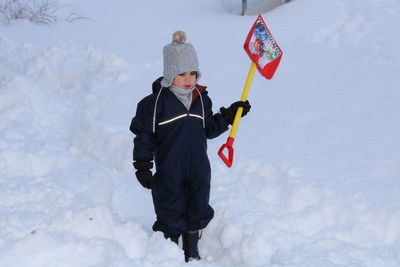 Portrait of boy standing on snow