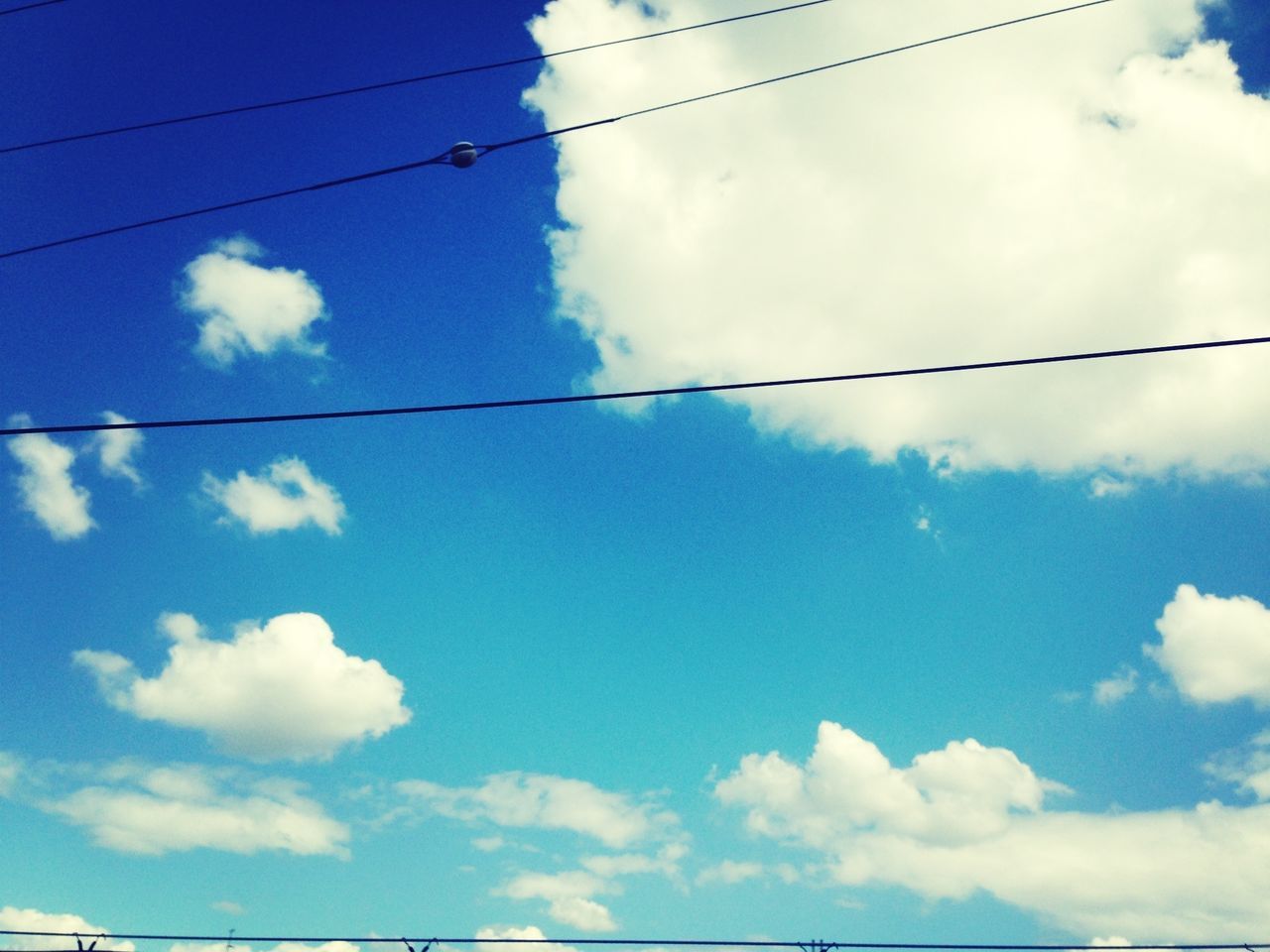 sky, power line, low angle view, cable, cloud - sky, electricity, power supply, electricity pylon, connection, cloud, cloudy, blue, power cable, fuel and power generation, technology, day, outdoors, nature, no people, tranquility