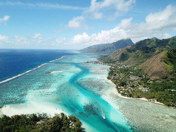 Aerial view of sea and mountains against sky