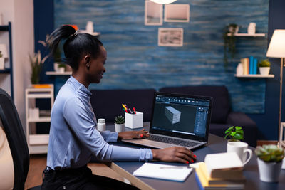 Rear view of businesswoman working at office