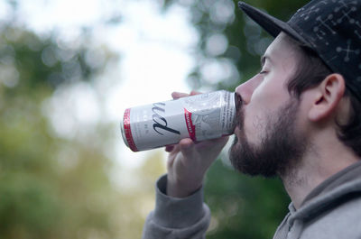 Portrait of young man drinking water