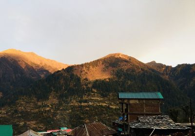 House on mountain against sky