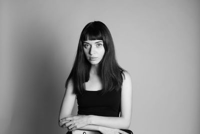 Portrait of beautiful young woman against white background