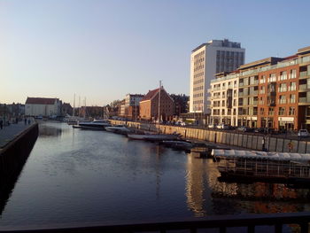 View of city by river against clear sky