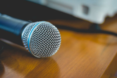 Close-up of microphone on wooden table