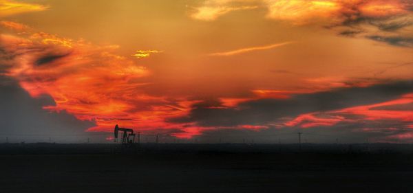 Silhouette landscape against sky during sunset