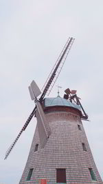 Low angle view of traditional windmill against sky