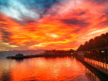 Scenic view of lake against orange sky