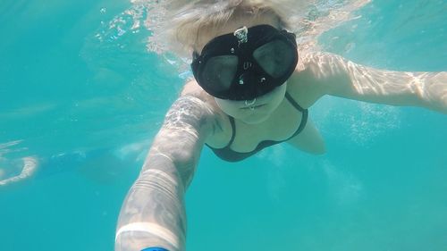 Portrait of young woman swimming in pool