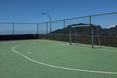 Empty soccer field against clear sky