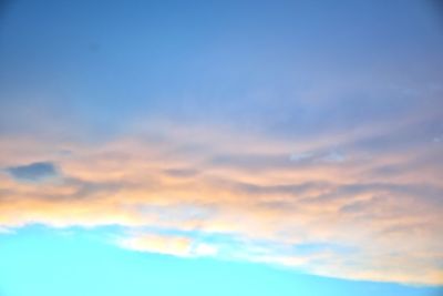 Low angle view of cloudy sky at sunset