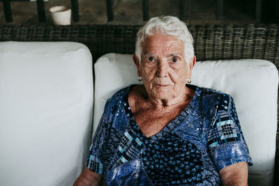 Portrait of old lady in her 80s relaxed at home.