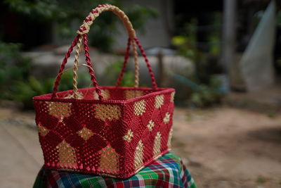 Close-up of wicker basket hanging on rope