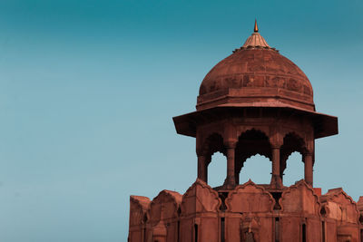 Low angle view of old building against blue sky