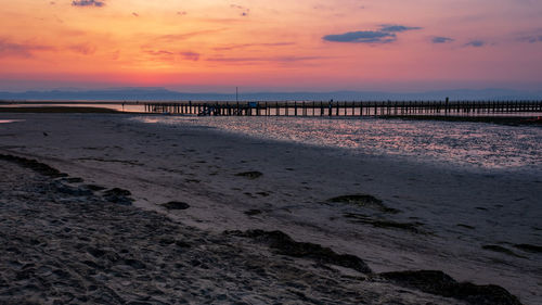 Scenic view of beach against sky during sunrise in grado, italy.