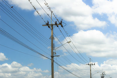 Low angle view of electricity pylon against sky