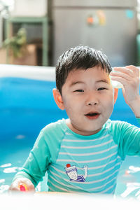 Portrait of cute boy playing in pool