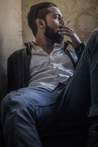 Young man sitting on table