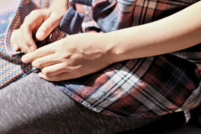 Low section of woman sitting outdoors