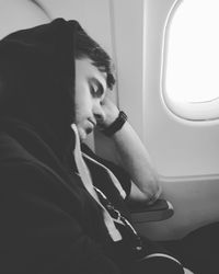 Side view of man sleeping in airplane