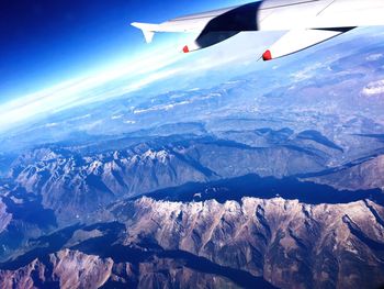 Aerial view of snowcapped mountains against sky