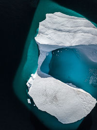 High angle view of iceberg in sea during winter