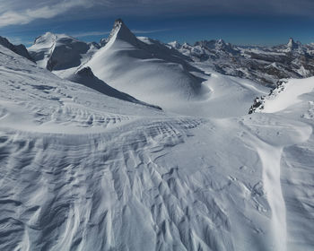 Scenic view of snow covered mountains against sky