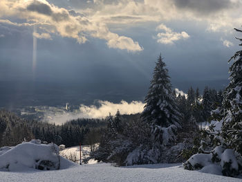 Scenic view of snow covered field against sky