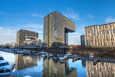 Reflection of buildings in city against sky