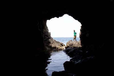 Scenic view of sea seen through cave