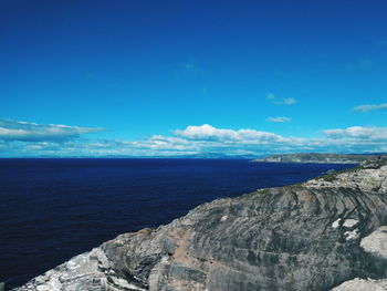 Scenic view of sea against blue sky