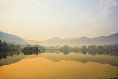 Scenic view of lake and mountains against sky