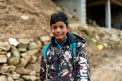 Portrait of smiling young man standing outdoors