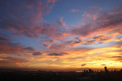 Scenic view of buildings against sky during sunset