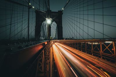 Light trails on suspension bridge at night