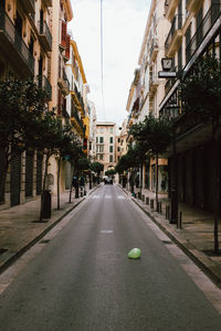 Street amidst buildings in city against sky