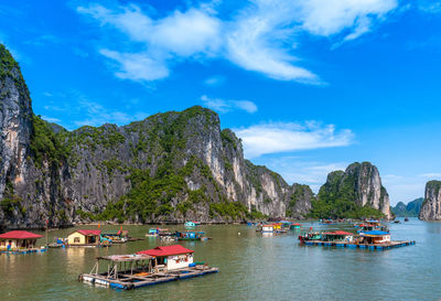 Boats moored in sea against sky