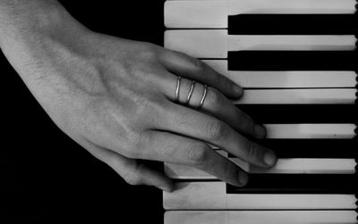 Close-up of hands playing piano