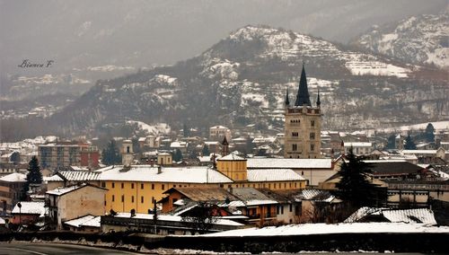 High angle view of townscape against mountains during winter