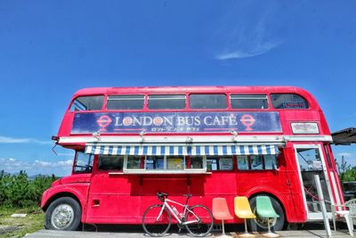 Red telephone booth against blue sky