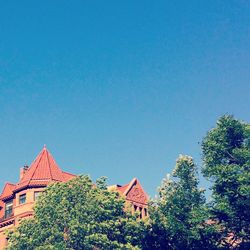 Low angle view of building against clear blue sky